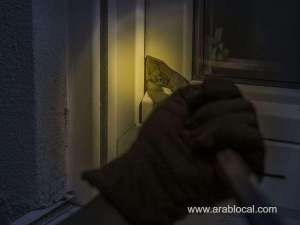 burglar-attempting-to-break-into-a-house-through-a-window-while-a-young-student-was-attending-an-online-class_UAE