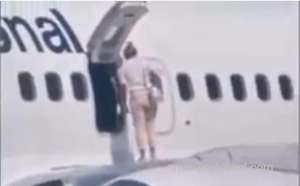 woman-traveler-sits-on-flight-wing-after-landing-in-ukraine_UAE